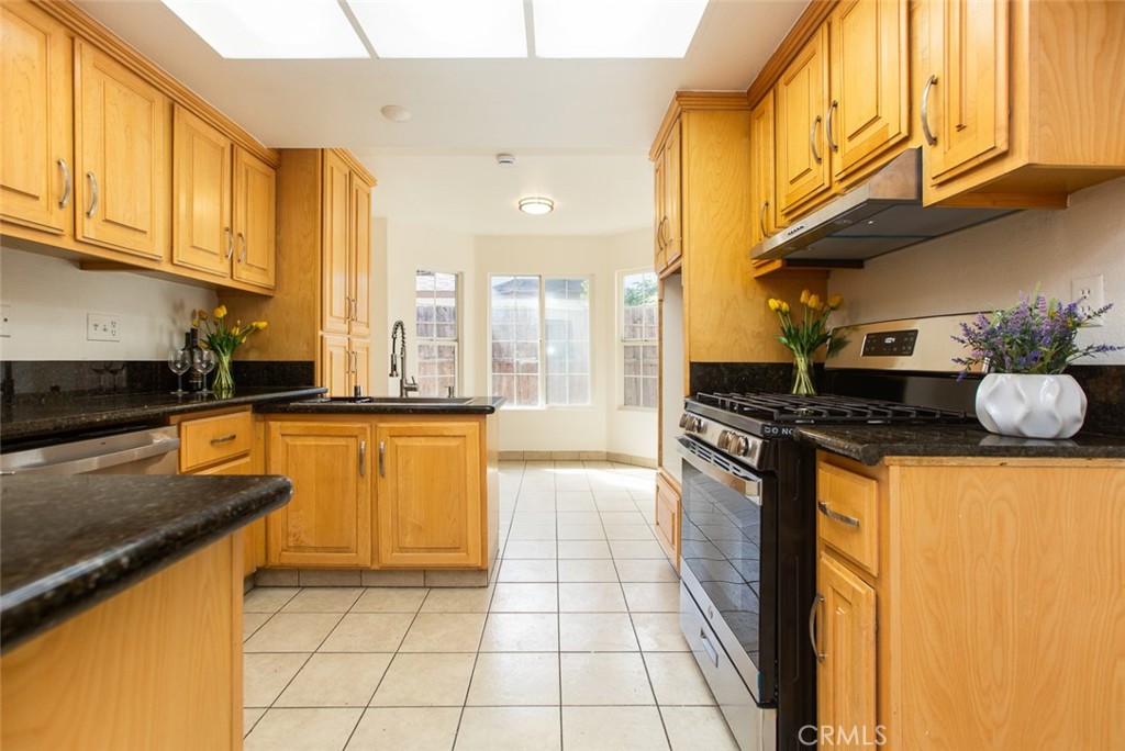 3790 Nut Tree Lane Riverside, CA 92501 - Photo 12 of 31 a kitchen with stainless steel appliances granite countertop a stove a sink and a microwave