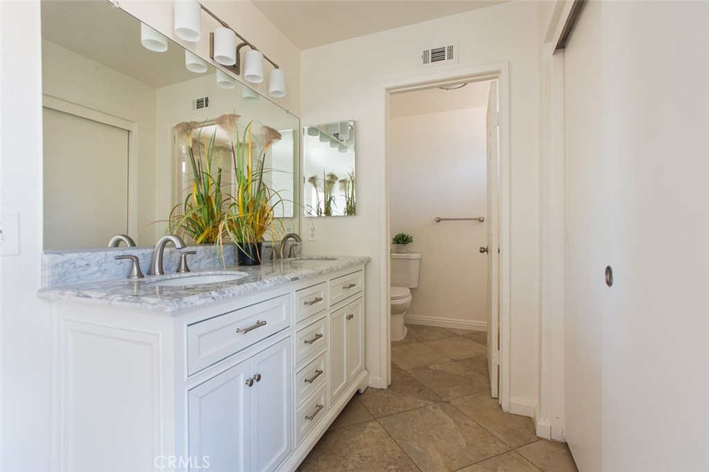 3790 Nut Tree Lane Riverside, CA 92501 - Photo 17 of 31 a bathroom with a granite countertop sink mirror and a