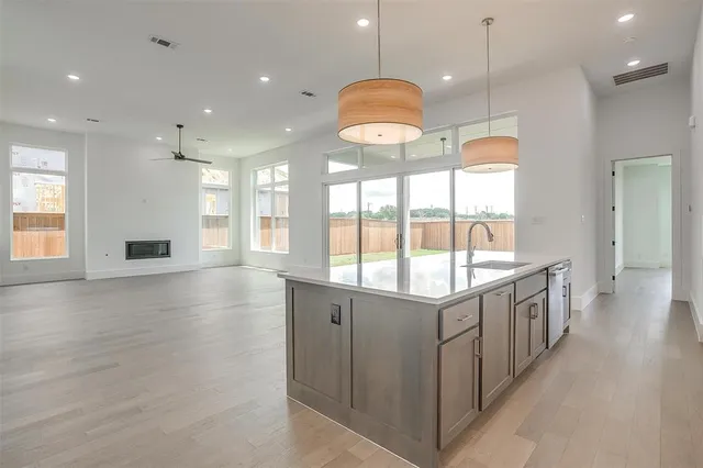 a kitchen with stainless steel appliances granite countertop counter space and wooden floors
