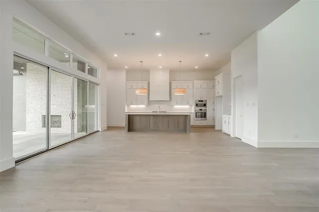 an empty room with a ceiling fan and window