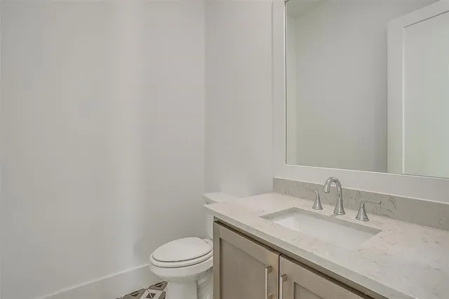 a view of cabinets and utility room with closet