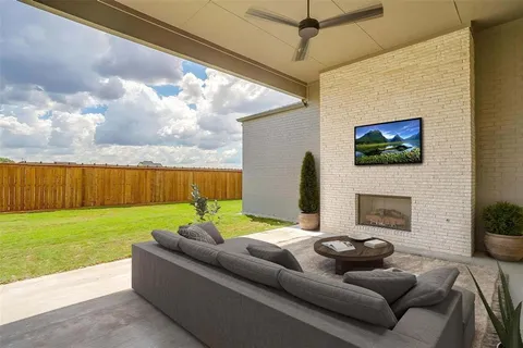 a view of an empty room with a fireplace and a window
