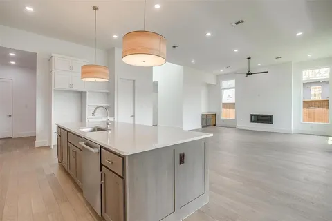 a kitchen with kitchen island a sink stainless steel appliances and cabinets