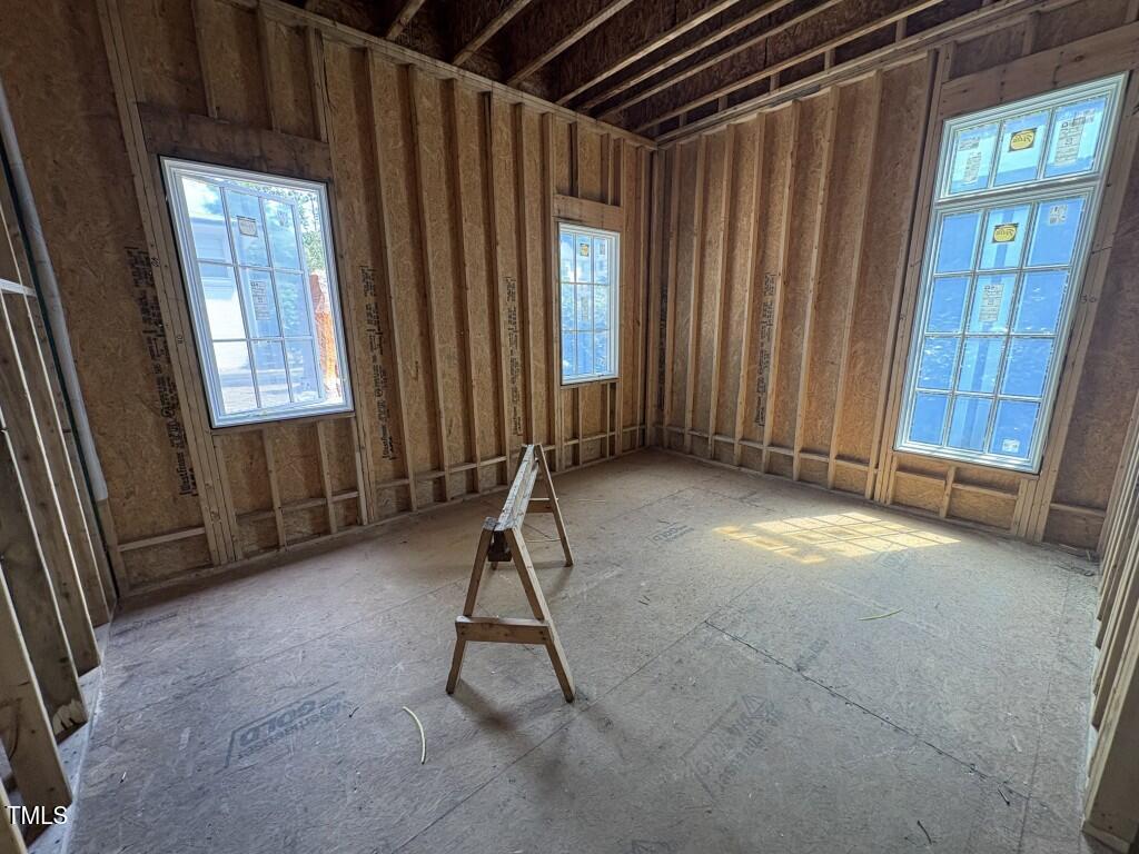 3358 Hampton Road Raleigh, NC 27607 - Photo 8 of 27 a view of an empty room with a window and hardwood floor