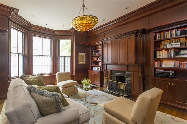 a living room with furniture a flat screen tv and a chandelier