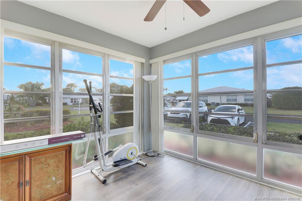 211 Manatee Lane, Unit D Fort Pierce, FL 34982 - Photo 12 of 25 a room with gym equipment and large windows
