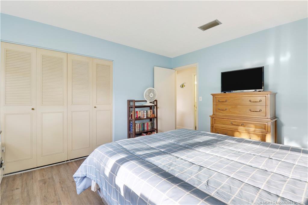 211 Manatee Lane, Unit D Fort Pierce, FL 34982 - Photo 15 of 25 a bedroom with a bed and a television