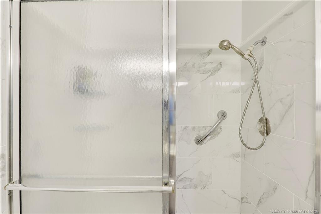 211 Manatee Lane, Unit D Fort Pierce, FL 34982 - Photo 22 of 25 a bathroom with a glass shower door