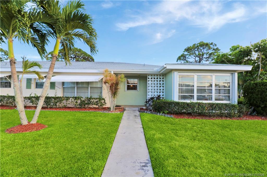 211 Manatee Lane, Unit D Fort Pierce, FL 34982 - Photo 23 of 25 a front view of a house with a yard