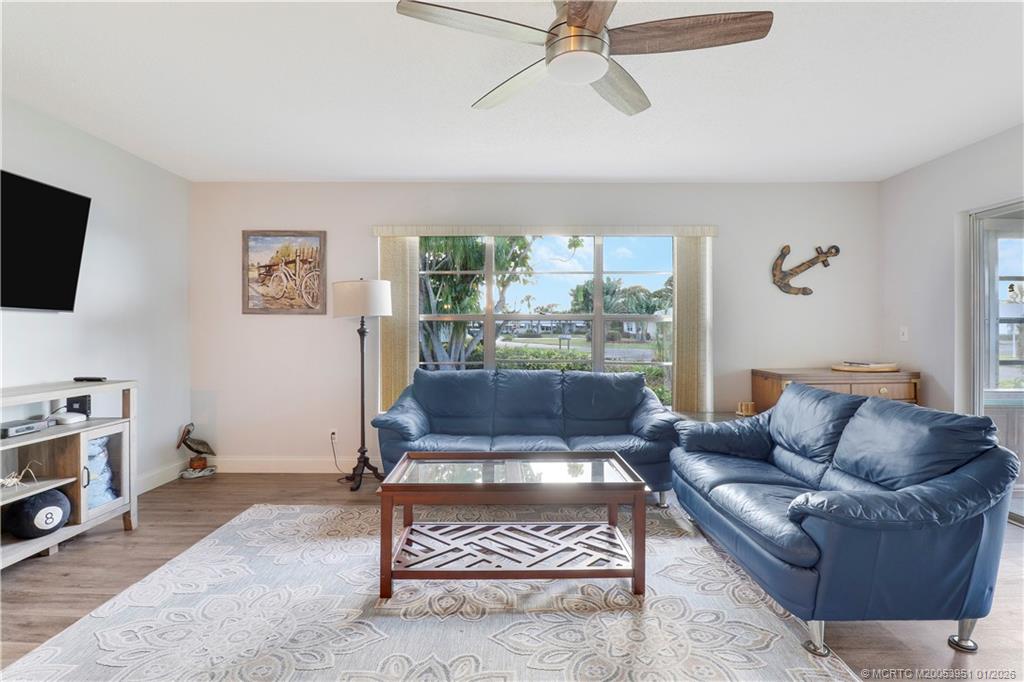 211 Manatee Lane, Unit D Fort Pierce, FL 34982 - Photo 3 of 25 a living room with furniture a flat screen tv and a window