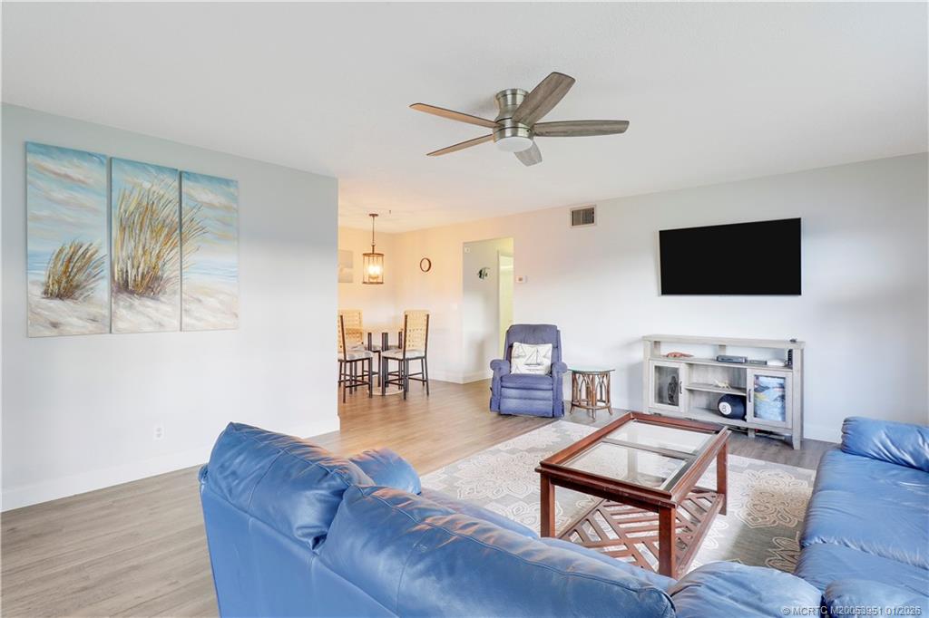 211 Manatee Lane, Unit D Fort Pierce, FL 34982 - Photo 5 of 25 a living room with furniture and a flat screen tv