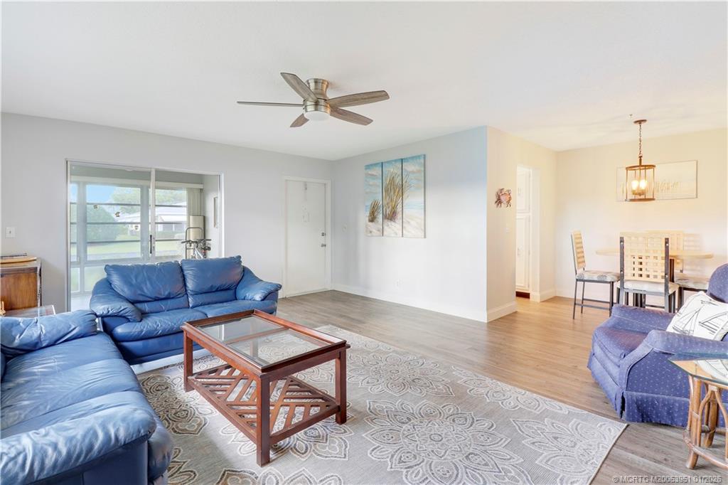 211 Manatee Lane, Unit D Fort Pierce, FL 34982 - Photo 6 of 25 a living room with furniture and wooden floor