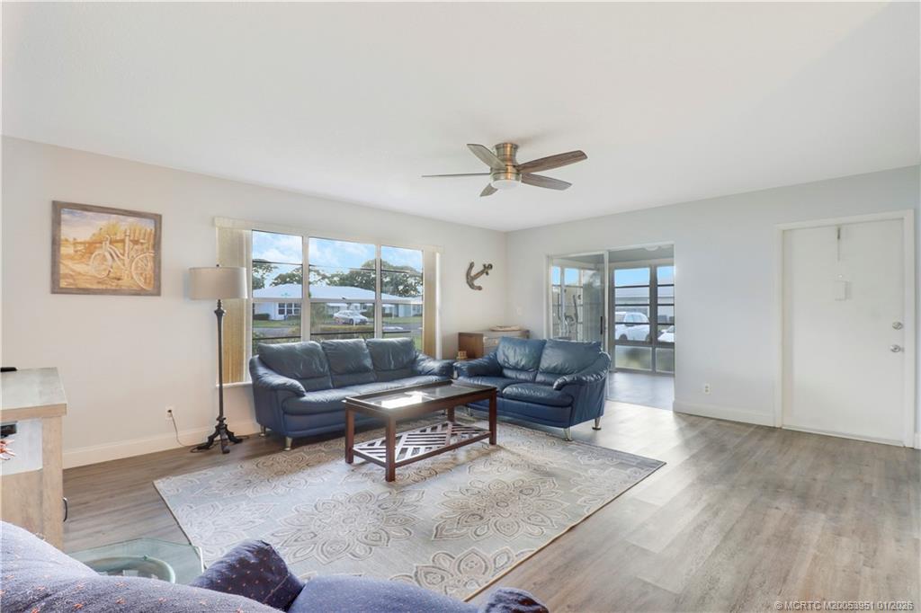 211 Manatee Lane, Unit D Fort Pierce, FL 34982 - Photo 7 of 25 a living room with furniture and a large window