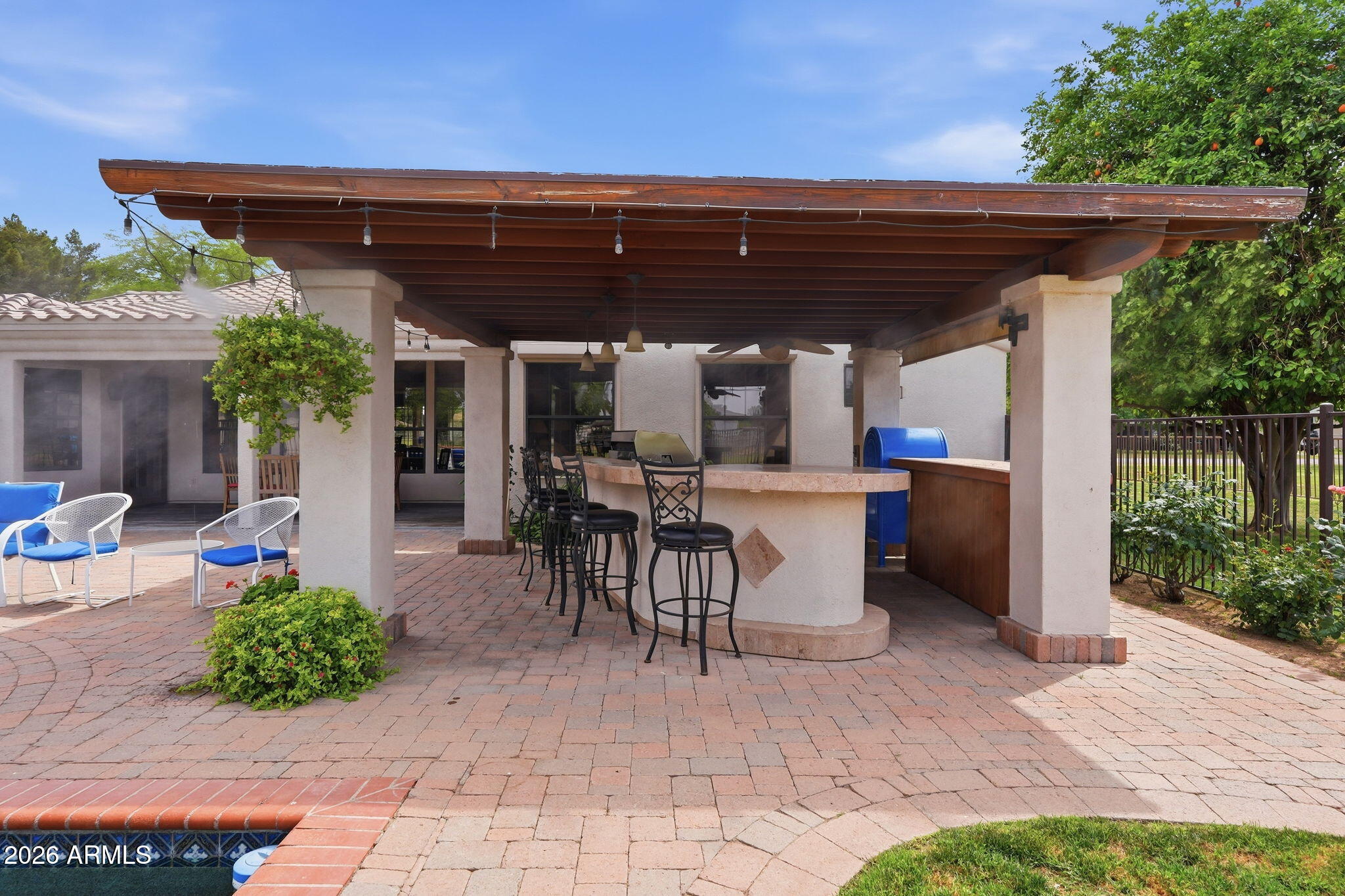 332 East Harrison Street Gilbert, AZ 85295 - Photo 21 of 101 a view of a patio with table and chairs potted plants and floor to ceiling window