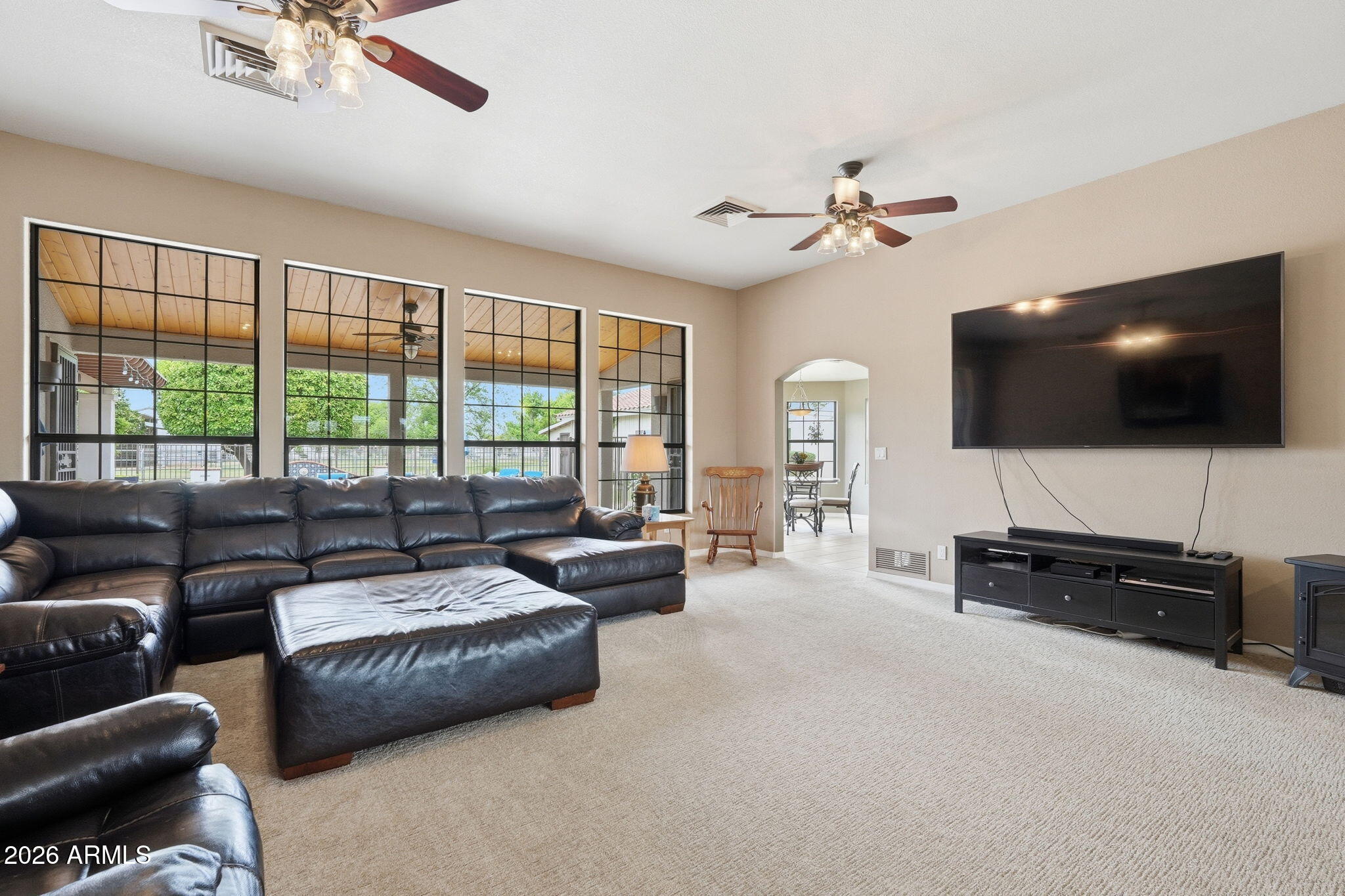 332 East Harrison Street Gilbert, AZ 85295 - Photo 24 of 101 a living room with furniture a flat screen tv and a large window