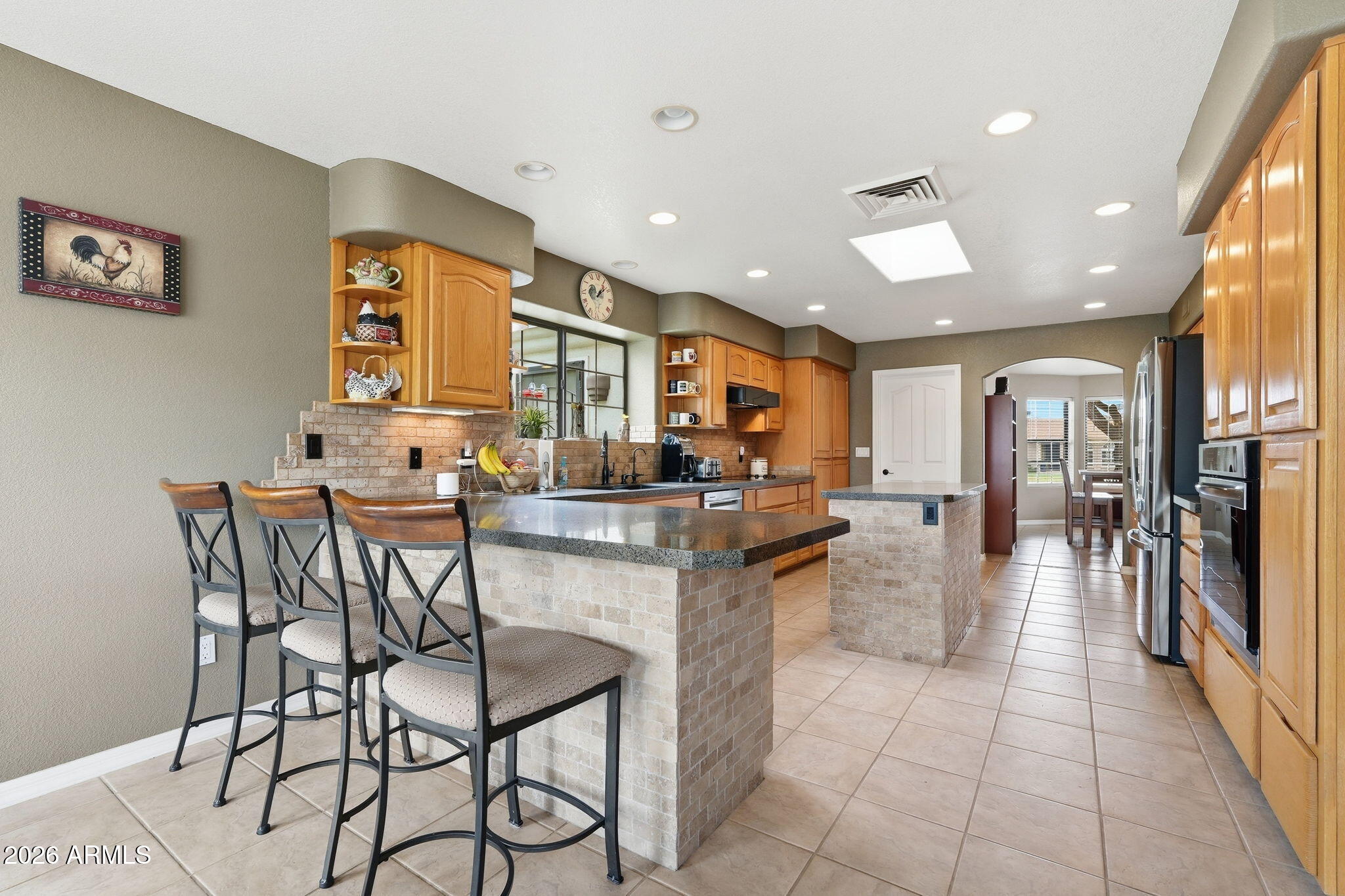 332 East Harrison Street Gilbert, AZ 85295 - Photo 29 of 101 a kitchen with stainless steel appliances kitchen island granite countertop a table and chairs