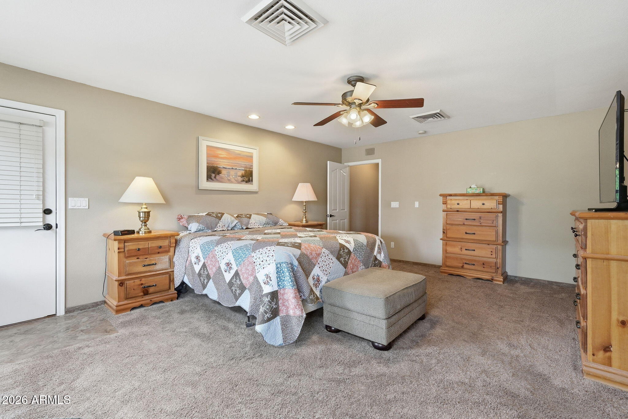 332 East Harrison Street Gilbert, AZ 85295 - Photo 44 of 101 a spacious bedroom with a bed a couch and a chandelier