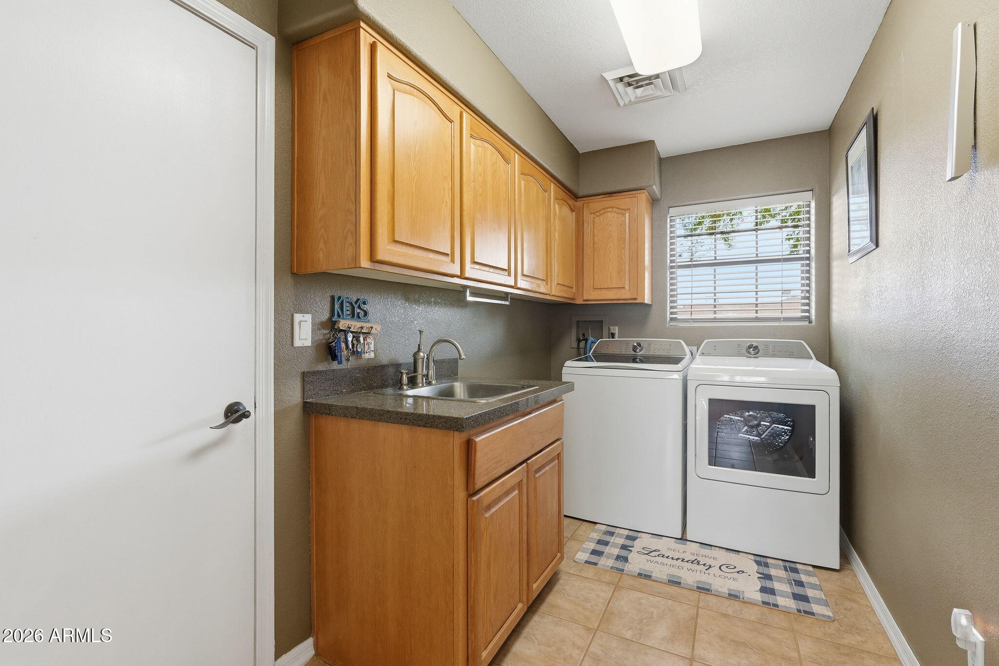 332 East Harrison Street Gilbert, AZ 85295 - Photo 54 of 101 a utility room with cabinets washer and dryer