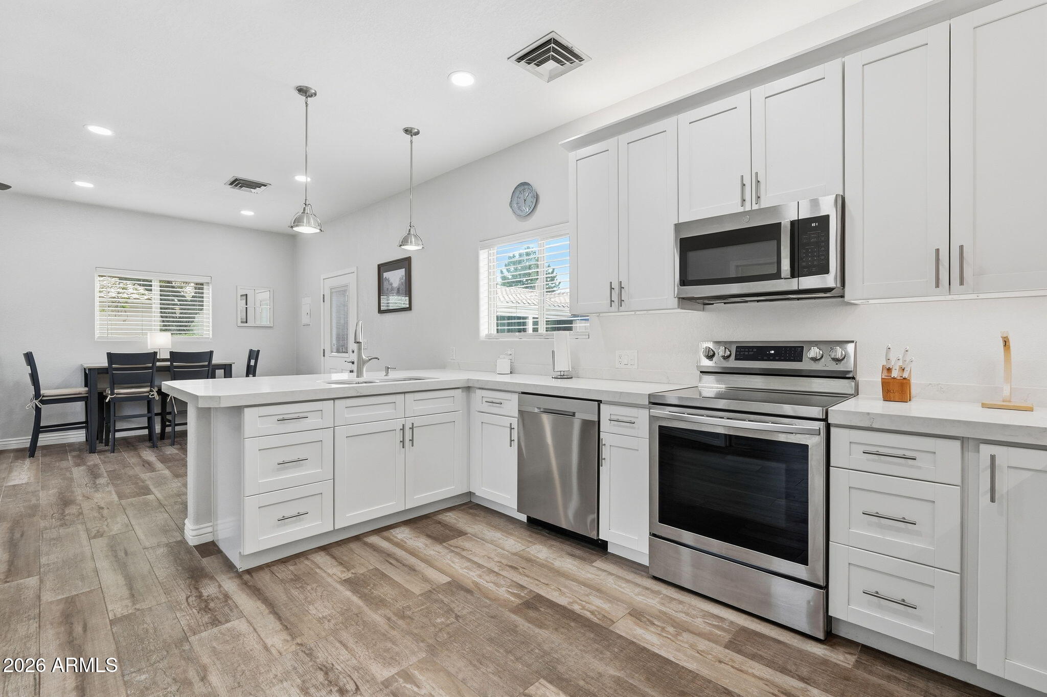 332 East Harrison Street Gilbert, AZ 85295 - Photo 57 of 101 a kitchen with stainless steel appliances granite countertop a stove a sink and a microwave