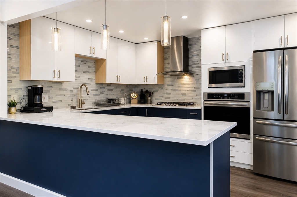 18 Ralston Road Boston, MA 02136 - Photo 2 of 26 a kitchen with stainless steel appliances a sink a stove a refrigerator and cabinets
