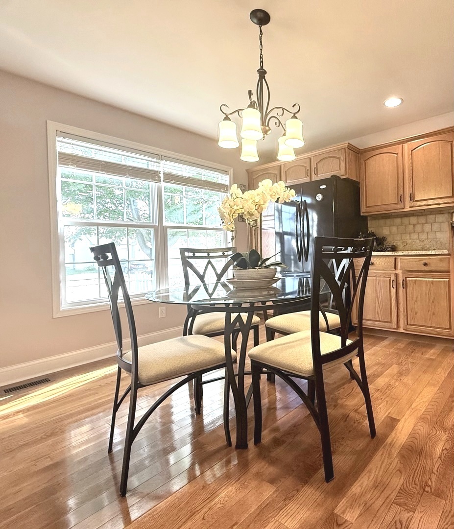 1606 East Marc Trail Urbana, IL 61802 - Photo 35 of 160 a view of a dining room with furniture window and wooden floor