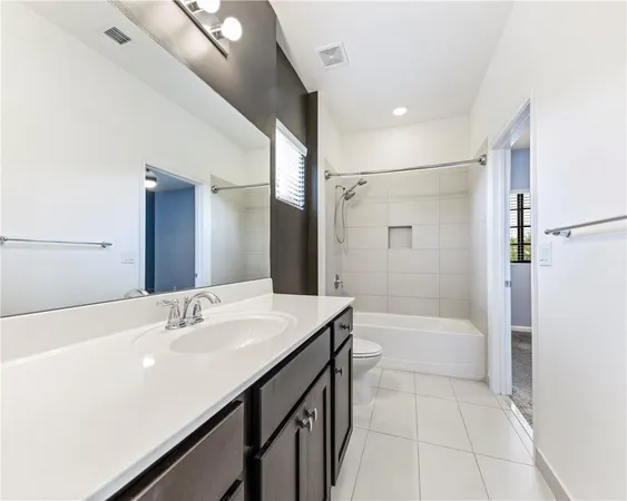 a bathroom with a bathtub shower sink vanity and a mirror