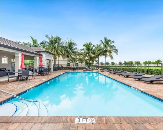 a swimming pool with outdoor seating and yard