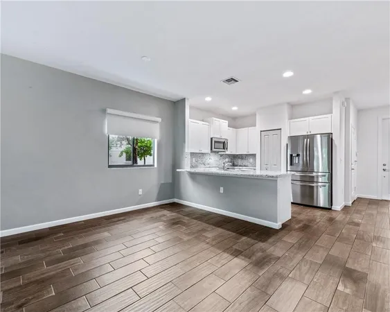 a view of kitchen with wooden floor
