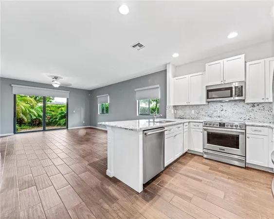 a kitchen with a stove a sink and a microwave