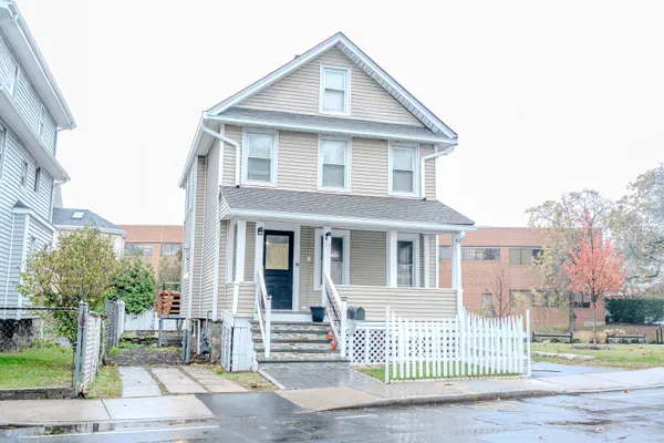 a front view of a house with a garden