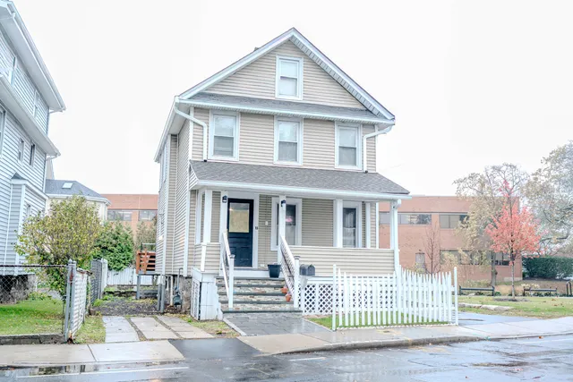 a front view of a house with a garden