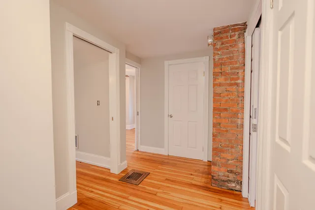 a view of room with window and wooden floor