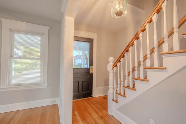 a view of entryway and hall with wooden floor