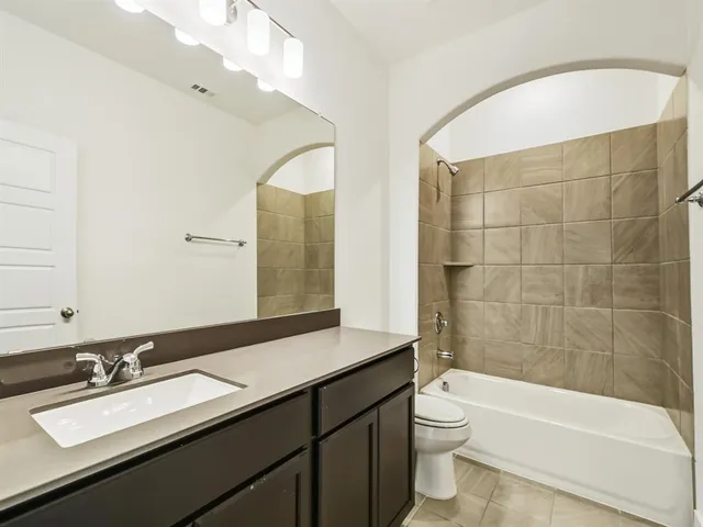 a bathroom with a bathtub a sink and a large mirror