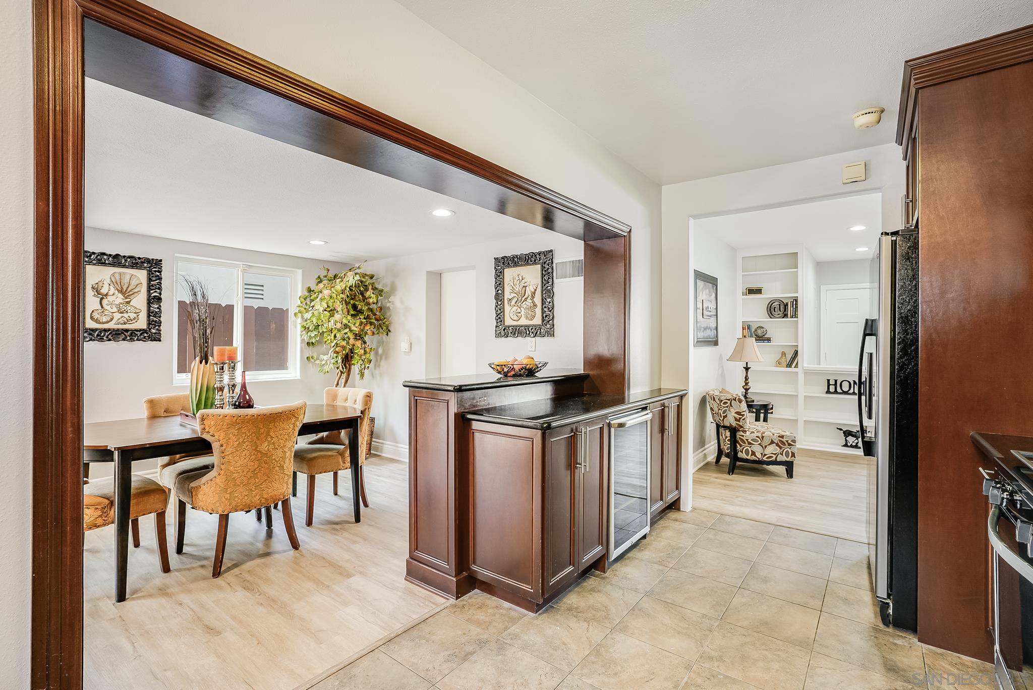 a open kitchen with stainless steel appliances kitchen island granite countertop a table and chairs in it
