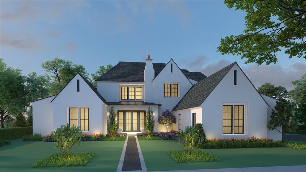 a front view of a house with a yard and green space