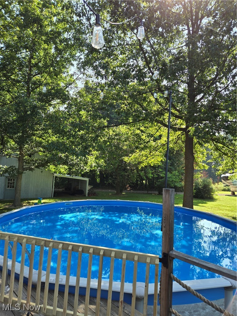 8584 Fisher Road Diamond, OH 44412 - Photo 49 of 50 Outdoor pool with an outdoor structure and view of wooded area