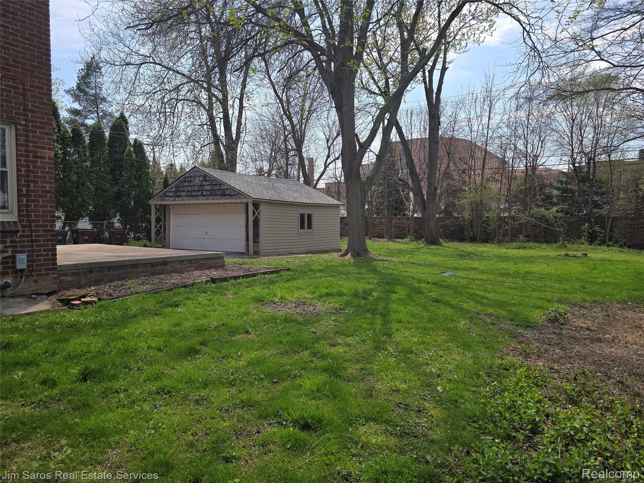 1705 Bournemouth Road Grosse Pointe, MI 48236 - Photo 16 of 20 View of grassy yard featuring an outdoor structure and a detached garage