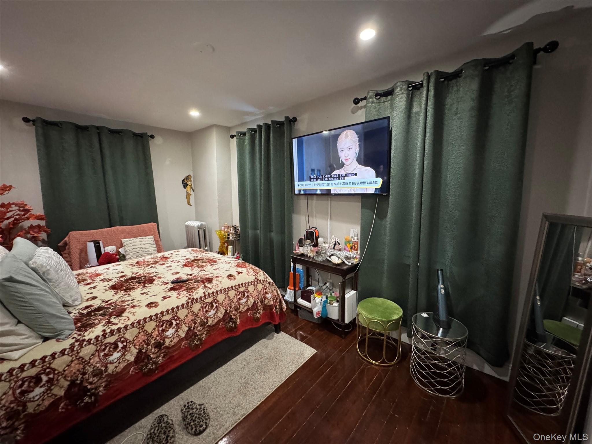 19 Hamilton Road Hempstead, NY 11550 - Photo 13 of 14 a bedroom with a bed and a flat screen tv