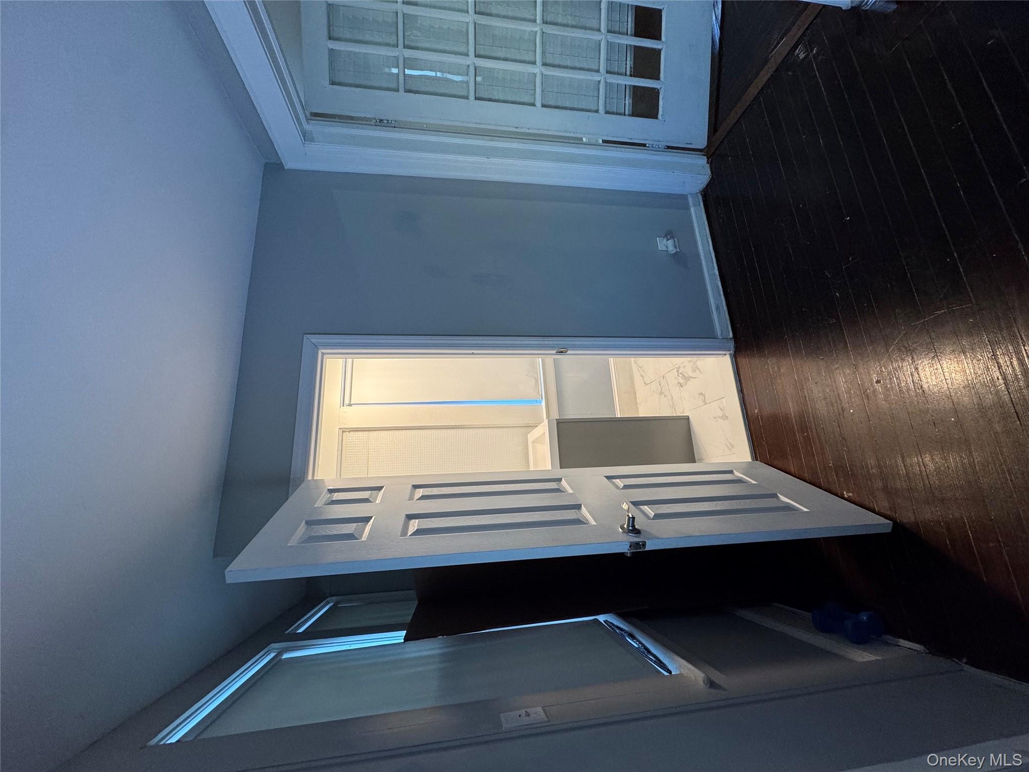 19 Hamilton Road Hempstead, NY 11550 - Photo 14 of 14 a view of an empty room with wooden floor and a window