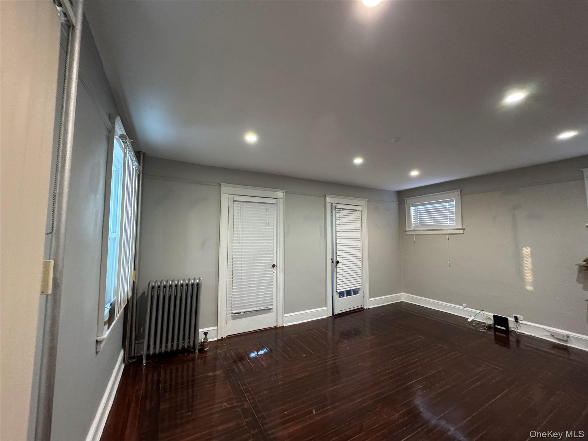 19 Hamilton Road Hempstead, NY 11550 - Photo 5 of 14 an empty room with wooden floor and a window