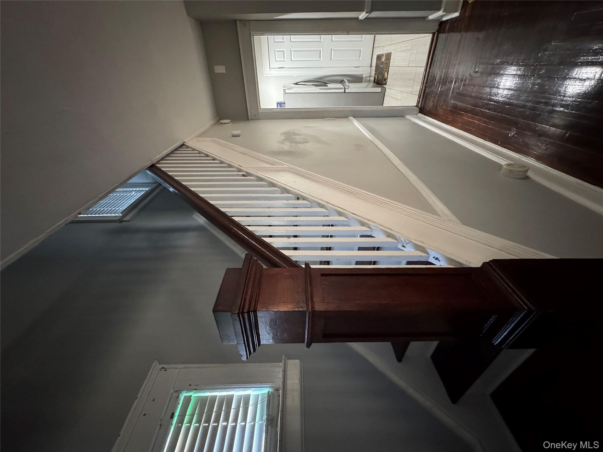 19 Hamilton Road Hempstead, NY 11550 - Photo 7 of 14 a view of entryway and hall with wooden floor