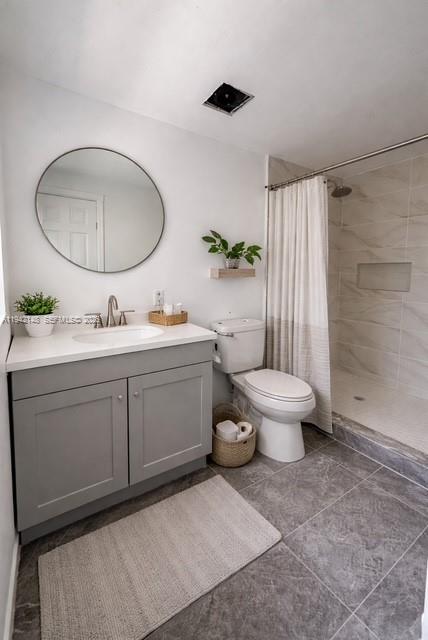 6875 Northwest 4th Avenue, Unit B Miami, FL 33150 - Photo 3 of 5 a spacious bathroom with a toilet sink and mirror