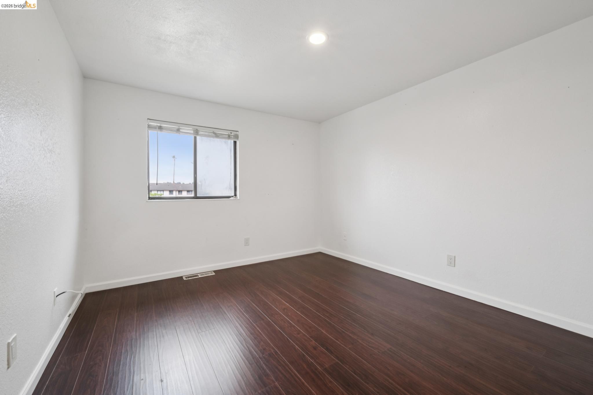 2600 Giant Road, Unit 35 San Pablo, CA 94806 - Photo 12 of 15 an empty room with wooden floor and windows