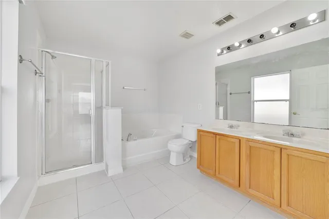 a bathroom with a granite countertop sink a toilet and shower
