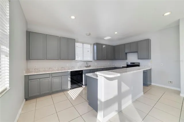 a kitchen with stainless steel appliances granite countertop a sink and a stove top oven