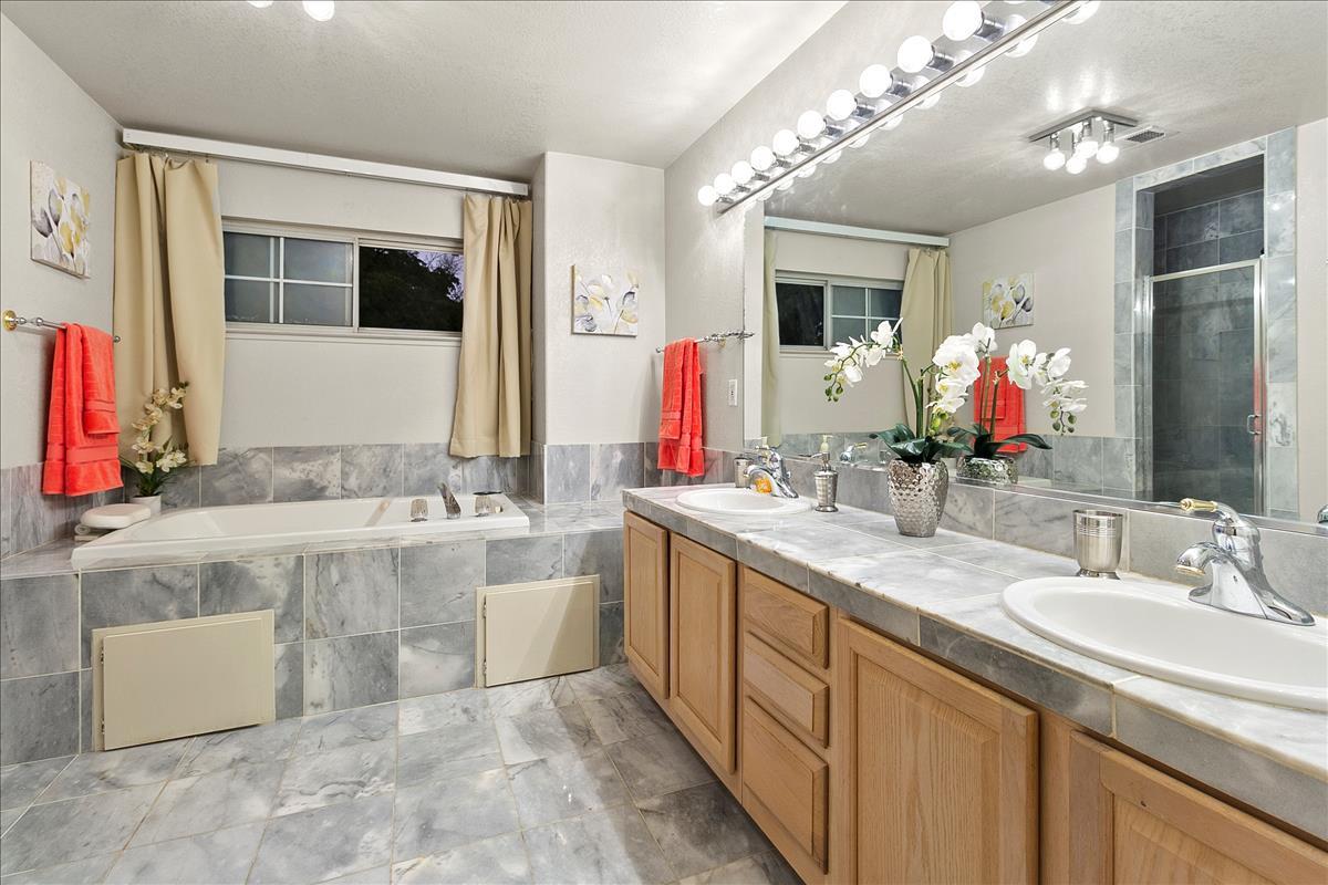 136 Redding Road Campbell, CA 95008 - Photo 23 of 30 a bathroom with a granite countertop double vanity sink and a mirror