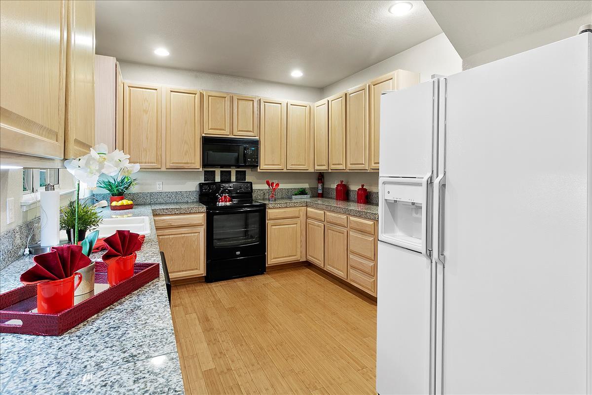136 Redding Road Campbell, CA 95008 - Photo 10 of 30 a kitchen with stainless steel appliances a sink a stove a refrigerator cabinets and a window