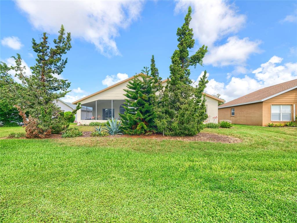 11228 Windrush Circle Hudson, FL 34667 - Photo 39 of 67 a front view of house with a garden