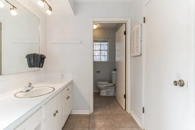 a white toilet sitting next to a bathroom sink